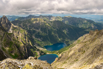 View from the mountain Rysy and Morskie Oko and Czarny Staw lakes. High Tatras. Border of Poland and Slovakia. Hiking in Slovakia. Beautiful landscape of mountain tops and the lake between them. 
