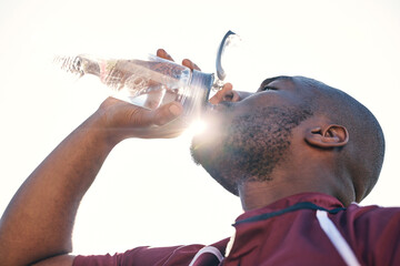 Black man, drinking water and health with fitness, athlete and sports with hydration and sunshine....