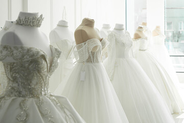 Beautiful wedding bridal dresses on mannequin in showroom in mall.