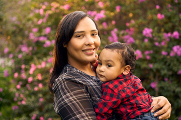 A beautiful Colombian mother with her 1-year-old boy in the nature