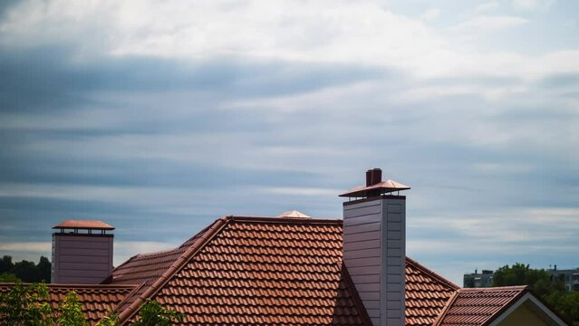 The roof of the house is made of red tiles, above the house. 4k timelapse shot