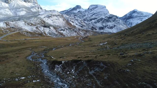 Young stream and first snow on the mountain peaks, drone image, Julierpass, Grisons, Switzerland, Europe
