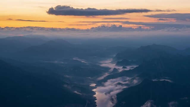 Berga, Catalunya, Spain. August 2022. Summer sunrise at the viewpoint of La Baells reservoir: moving clouds create a spectacle of light and shadow among the mountains.