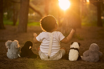 One-year-old baby in a park during the sunset