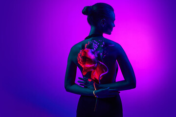 Back view. Portrait with sensual female silhouette and digital neon filter lights with flower on...