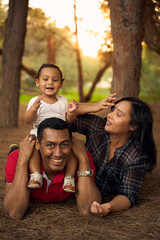 A beautiful family in a park with a one-year-old child