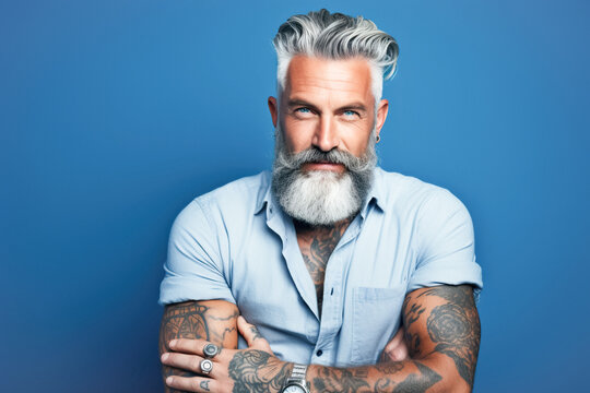 A happy young middle-aged man, with a well-groomed beard and a modern haircut, poses for the camera