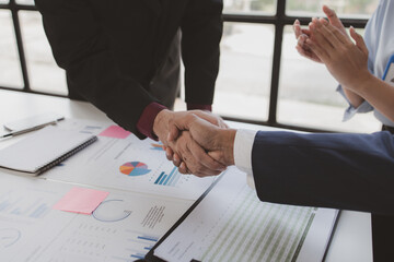 Business investor group holding hands, Two businessmen are agreeing on business together and shaking hands after a successful negotiation. Handshaking is a Western greeting or congratulation.