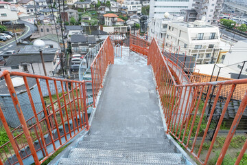 Minamiyamatemachi, Nagasaki, Japan. June 5, 2023. A unique playground set along a hillside with a large twisting roller slide and stairs with a view of Nagasaki city. 