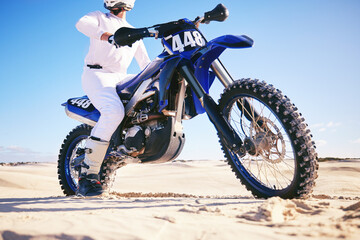 Sand, sports and man with motorbike in desert for adrenaline, adventure and freedom. Competition, extreme action and male person on bike on dunes for training, exercise and race for driving challenge