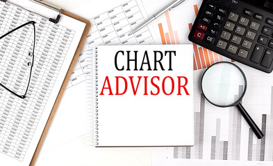 Obraz premium CHART ADVISOR text on notebook with clipboard and calculator on a chart background