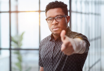 serious black businessman in glasses pointing at you