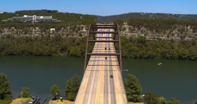 Establishing shot of the Pennybacker 360 Bridge over Lake Austin in Austin, Texas 