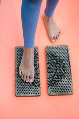 Womans foot standing on sadhu board closeup.
