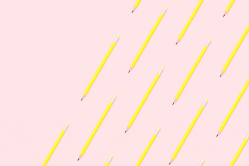 Yellow pencils flat lay on pink background