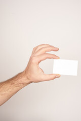 White male holding a business card on isolated white background.