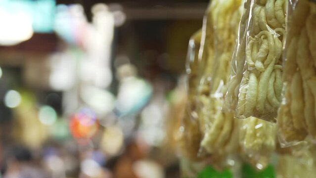 Dried fish maw in a plastic bag hanging at a dry food shop in Chinatown