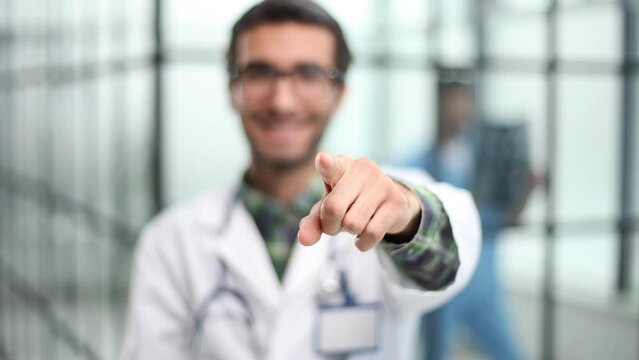 The doctor makes a positive sign for medicine with his finger.