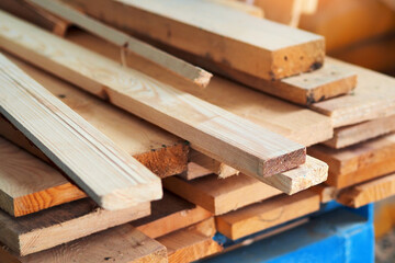 New planed wooden boards stacked in sawmill. Procurement and sale of building material. Dry wood. Woodworking. Background.