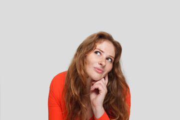 Thinking woman on white background, studio portrait