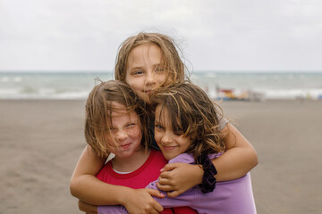 Fototapeta na wymiar Cute smiling kid playing on the beach. Adorable young girls outdoors portrait