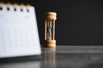 Close up image of calendar and hourglass with copy space. Deadline, time limit and period concept.