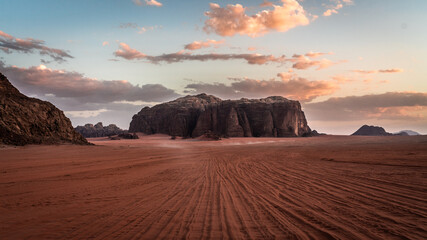 Large rock in center with many roadmarks in front at Wadi Rum desert, Jordan