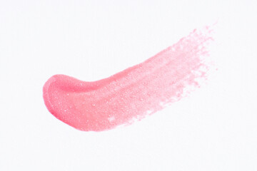 Light glitter pink paint swatch on white paper background. Pink swatch of lip gloss, cosmetic...