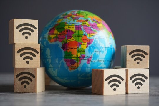 Closeup image of globe and wooden cubes with wifi icon. Internet and global network concept