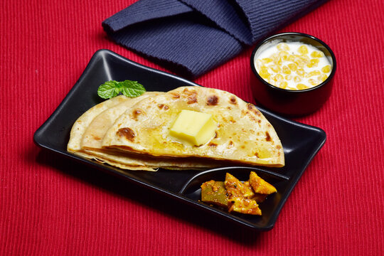 Butter paratha with raita and pickle healthy indian breakfast