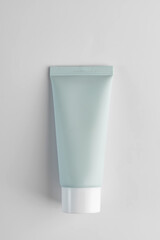 mockup of green squeeze bottle plastic tube for branding of medicine or cosmetics - cream, gel, skin care, toothpaste. Cosmetic bottle container on a white background. Minimalism
