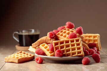 Belgian waffles with raspberries and black coffee.