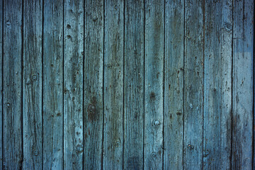 Old wooden blue planks fence textured Background with aged surface details. Weathered vintage rustic timber closeup