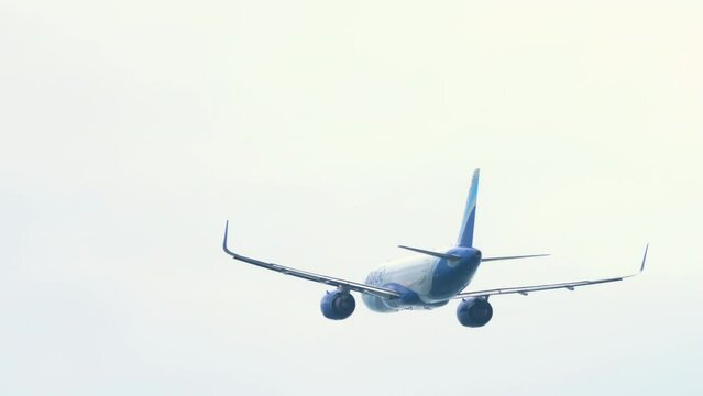 Passenger jet take off at Phuket airport. Flight departure. Aircraft leaving, climbing. Tourism and travel concept