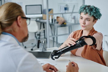 Portrait of young woman with colored hair consulting with prosthetist in orthology clinic