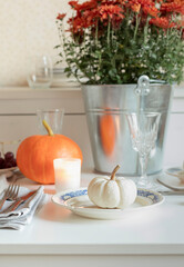 Autumn seasonal table settings with white and orange pumpkins. Thanksgiving festive table