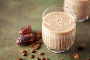 Coffee date smoothie creamy milkshake in glass. Healthy breakfast. Chunky monkey smoothie