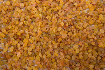 Dried fruits Yellow sweet delicious raisins pattern texture can be used as a background wallpaper