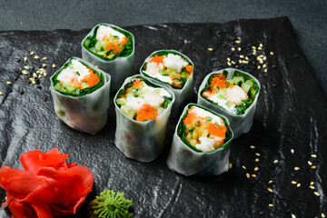Traditional fresh Japanese sushi rolls with shrimp in a rice sheet. Served with wasabi sauce and pickled ginger. Close up.