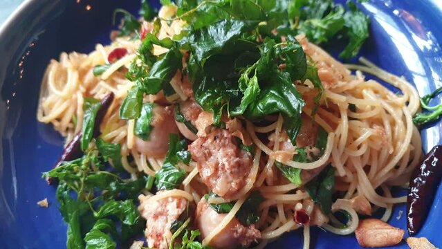 Thai style sphgetti fried noodle with fermented sausage basil garlic and chilli