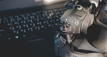 Camera lens and laptop computer of photographer for set create photo and adjust photo and maintenance dirty small dust in camera concept.