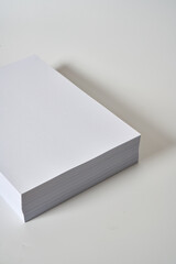 Pile of white and blank a4 paper on a white surface