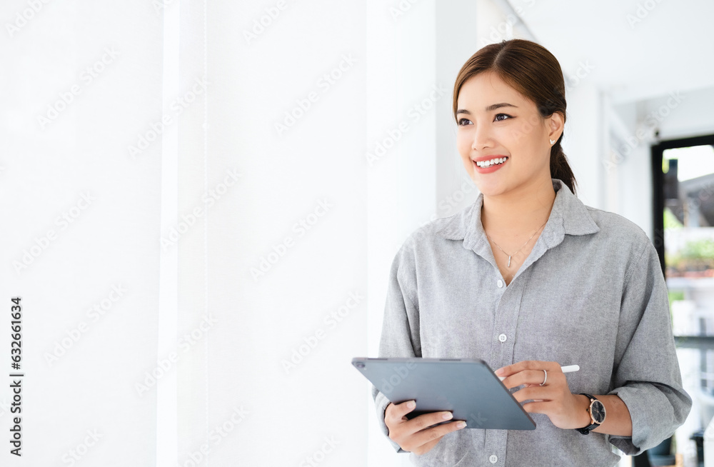 Wall mural Thinking about how to take the business to technological heights. attractive cheerful young businesswoman working in her office.