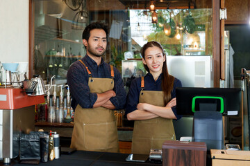 Hispanic man and coffee shop owner's wife Standing for a photo to promote the coffee shop. A small...