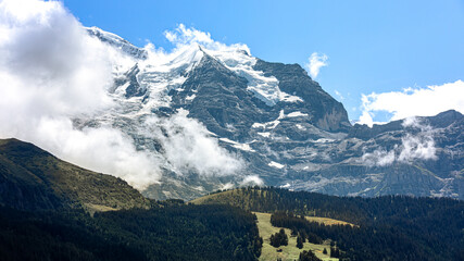 View to the snowy mountains of Jungfraujoch from the village Wengen near Lauterbrunnen in Switzerland
