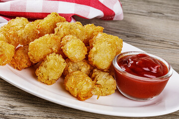 Close up of delicious Tater Tots on a wooden background