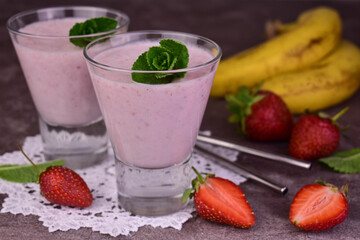 Two glasses of banana strawberry smoothie. Close-up.
