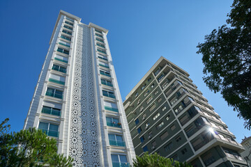 High and luxurious apartments with a summer blue sky on the background.