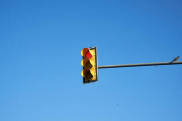 Traffic lights on a sunny blue sky.
