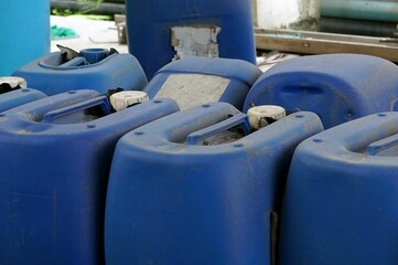 A old blue plastic canister for chemical in the factory, closeup of photo.